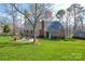 Spacious backyard features a well-maintained lawn, patio, and mature trees at 916 Somersby Ln, Matthews, NC 28105