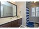 Bathroom with a vanity, large mirror, and a shower curtain, providing a functional space at 916 Somersby Ln, Matthews, NC 28105