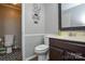 Bathroom with dark vanity and wood-look floors leading to shower at 916 Somersby Ln, Matthews, NC 28105