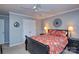 Comfortable bedroom with floral bedding and dark furniture, featuring ceiling fan and neutral tones at 916 Somersby Ln, Matthews, NC 28105