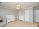 Bedroom with a white crib, changing table, and a soft gray rocking chair creating a serene atmosphere at 916 Somersby Ln, Matthews, NC 28105