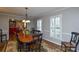 Formal dining area features wood table, chairs, rug and shuttered windows at 916 Somersby Ln, Matthews, NC 28105