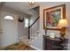 Welcoming foyer with hardwood floors, carpeted stairs, and tasteful decor, creating a warm entry at 916 Somersby Ln, Matthews, NC 28105