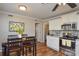 Kitchen area with stainless steel appliances, white cabinets, and wood-look flooring at 916 Somersby Ln, Matthews, NC 28105