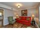 Comfortable living room with a red sofa, green chairs, and a floral painting at 916 Somersby Ln, Matthews, NC 28105