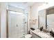 Bathroom featuring a glass-enclosed shower, granite counters, white cabinets, and neutral tile at 9300 Vecchio Dr, Indian Land, SC 29707