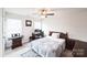 Bedroom featuring neutral carpet, a ceiling fan, and a computer desk with natural light from two windows at 9300 Vecchio Dr, Indian Land, SC 29707