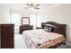 Bedroom with a ceiling fan, neutral carpet, a dresser, and large windows that provide natural light at 9300 Vecchio Dr, Indian Land, SC 29707