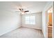 Bedroom featuring neutral carpet, a ceiling fan, and a large window for plenty of natural light at 9300 Vecchio Dr, Indian Land, SC 29707