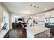 Open floorplan featuring kitchen with granite counters, island and stainless steel appliances connecting to dining and living room at 9300 Vecchio Dr, Indian Land, SC 29707