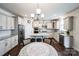 Well-lit kitchen featuring granite countertops, stainless steel appliances, an island, and a breakfast nook with chandelier at 9300 Vecchio Dr, Indian Land, SC 29707