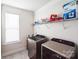 This laundry room features modern washer and dryer and convenient shelving at 9300 Vecchio Dr, Indian Land, SC 29707