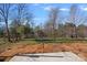 Large, fenced backyard features an expansive lawn and mature trees, perfect for outdoor enjoyment at 1009 Rocky Meadows Ln, Concord, NC 28025