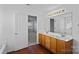 Bathroom featuring wood cabinets, double sinks, vanity and large mirror at 1009 Rocky Meadows Ln, Concord, NC 28025