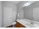 A well-lit bathroom with vanity, mirror, white toilet, and dark hardwood floors at 1009 Rocky Meadows Ln, Concord, NC 28025