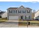 Charming two-story home features a two-car garage, well-manicured lawn, and inviting curb appeal at 1009 Rocky Meadows Ln, Concord, NC 28025