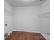 Laundry room area with laminate flooring and wire shelving at 1009 Rocky Meadows Ln, Concord, NC 28025