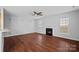 Bright living room showcasing a fireplace, ceiling fan, and hardwood floors, ideal for comfortable living and relaxation at 1009 Rocky Meadows Ln, Concord, NC 28025