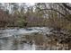 Serene water view with natural rock formations, showcasing a picturesque landscape at 1009 Rocky Meadows Ln, Concord, NC 28025