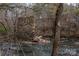 Tranquil water view featuring a historic stone ruin in a wooded, natural landscape at 1009 Rocky Meadows Ln, Concord, NC 28025