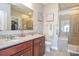 Bathroom featuring a double sink vanity with granite countertops and a tiled shower with glass doors at 116 Paradise Hills Cir, Mooresville, NC 28115