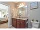 Bathroom featuring a double sink vanity with granite countertops, a toilet, and decorative accents at 116 Paradise Hills Cir, Mooresville, NC 28115