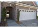 Close up of a charming home's entrance and garage featuring brick accents and a well-maintained exterior at 116 Paradise Hills Cir, Mooresville, NC 28115