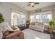 Cozy sunroom with many windows, comfortable seating, and an area rug at 116 Paradise Hills Cir, Mooresville, NC 28115