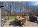 Relaxing backyard patio area with stylish outdoor furniture and a peaceful wooded view at 1161 Woodwinds Dr, Waxhaw, NC 28173