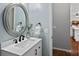 Powder room features a sleek sink with a large mirror, modern fixtures, and neutral walls at 1161 Woodwinds Dr, Waxhaw, NC 28173