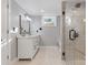 Modern bathroom with a marble vanity, elegant mirror, and a glass-enclosed shower at 1206 9Th Nw St, Hickory, NC 28601