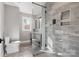 Modern bathroom with gray tiled shower, vanity, and flooring, creating a clean and contemporary design at 1206 9Th Nw St, Hickory, NC 28601