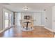 Cozy dining room area with hardwood floors, a dartboard, and plenty of natural light with access to the outdoors at 1206 9Th Nw St, Hickory, NC 28601