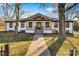 Charming home featuring a covered front porch with modern railing, steps leading to the entry, and landscaped yard at 1206 9Th Nw St, Hickory, NC 28601