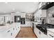 Contemporary kitchen with stainless steel appliances, quartz countertops, white cabinets, and sleek finishes at 1206 9Th Nw St, Hickory, NC 28601