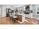Modern kitchen featuring stainless steel appliances, sleek white cabinetry, and a rustic wood-accented island at 1206 9Th Nw St, Hickory, NC 28601