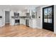 Modern kitchen featuring stainless steel appliances, white cabinets, gray backsplash, and a sleek black door at 1206 9Th Nw St, Hickory, NC 28601