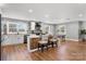 Well-lit kitchen with a central island, white cabinetry, stainless steel appliances, and an adjacent dining area at 1206 9Th Nw St, Hickory, NC 28601