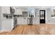 Well-lit kitchen with stainless steel appliances, white cabinetry, and a stylish gray backsplash at 1206 9Th Nw St, Hickory, NC 28601