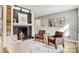 Cozy living room featuring a black brick fireplace, mantel, and hardwood floors, creating a warm and inviting space at 1206 9Th Nw St, Hickory, NC 28601