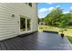 Outdoor back deck area shows freshly painted deck with potted plants overlooking backyard lawn and shade trees at 1226 Flint Ct, Matthews, NC 28104