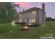Tranquil backyard featuring a fire pit and a dark wooden deck at 1226 Flint Ct, Matthews, NC 28104