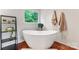 Beautiful bathroom featuring a standalone tub, wood floors, and natural light at 1226 Flint Ct, Matthews, NC 28104