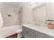 Bright bathroom features modern vanity, framed mirror, and tiled shower with niche at 1226 Flint Ct, Matthews, NC 28104
