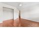 Clean and minimalist bedroom with hardwood floors, walk-in closet, and white trim at 1226 Flint Ct, Matthews, NC 28104