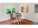 Bright breakfast nook features wood floors, a round table, and a window view of the yard at 1226 Flint Ct, Matthews, NC 28104