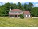 Beautiful two-story home featuring a well-manicured lawn and mature trees at 1226 Flint Ct, Matthews, NC 28104