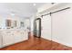 Modern kitchen with stainless steel appliances, ample storage, and a sliding barn door to the living area at 1226 Flint Ct, Matthews, NC 28104