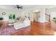 Spacious living room with hardwood floors, comfy sofa, and a sliding barn door leading to the powder room at 1226 Flint Ct, Matthews, NC 28104