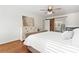 Bright main bedroom featuring wood floors, ceiling fan, and ensuite bath with sliding barn door at 1226 Flint Ct, Matthews, NC 28104